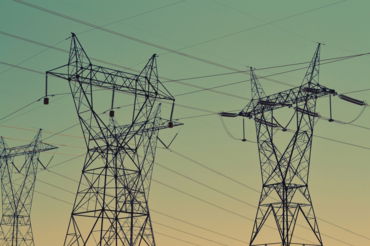 black-transmission-towers-under-green-sky.jpg black transmission towers under green sky